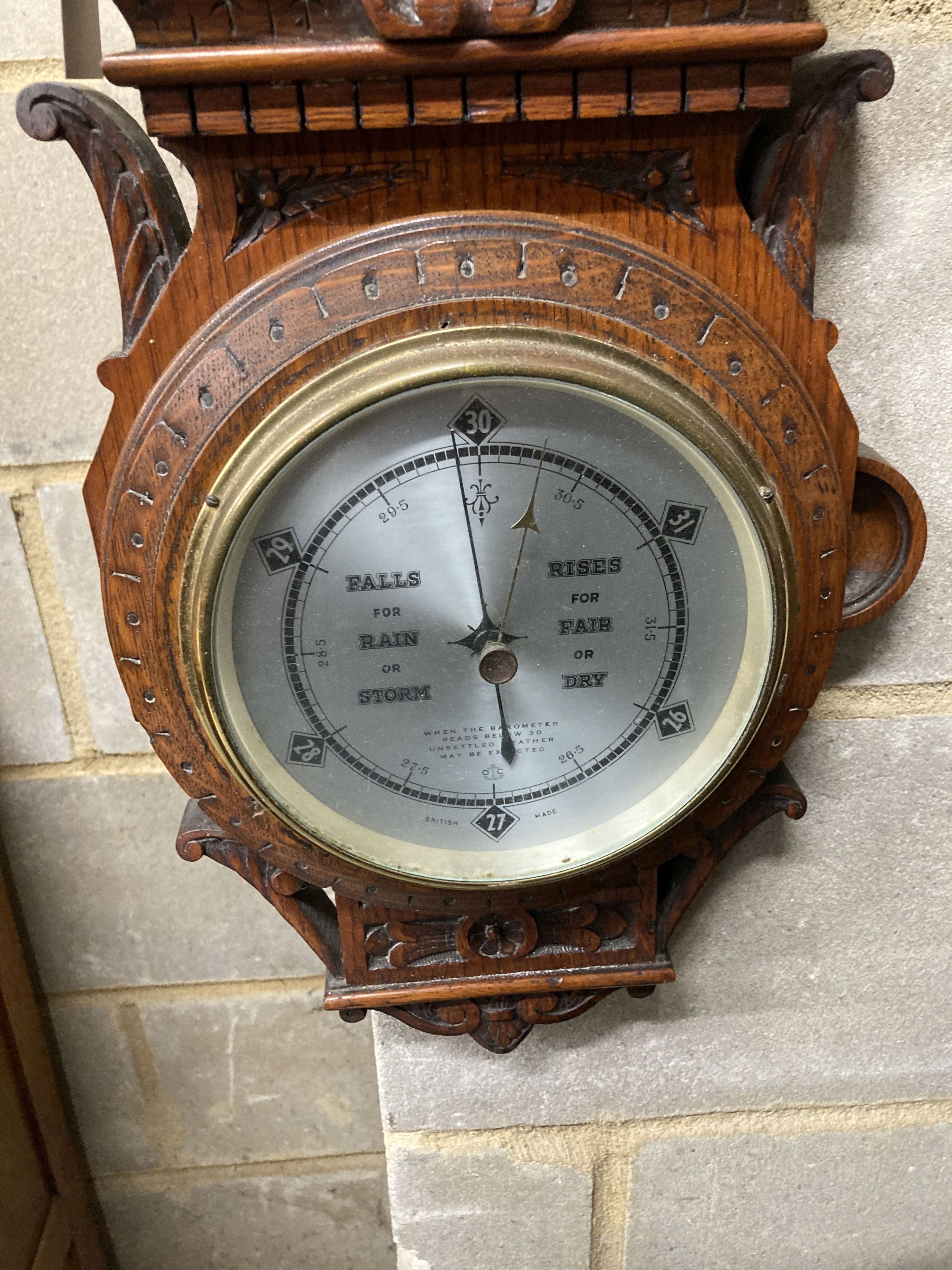 An Edwardian carved oak aneroid barometer and thermometer, height 80cm